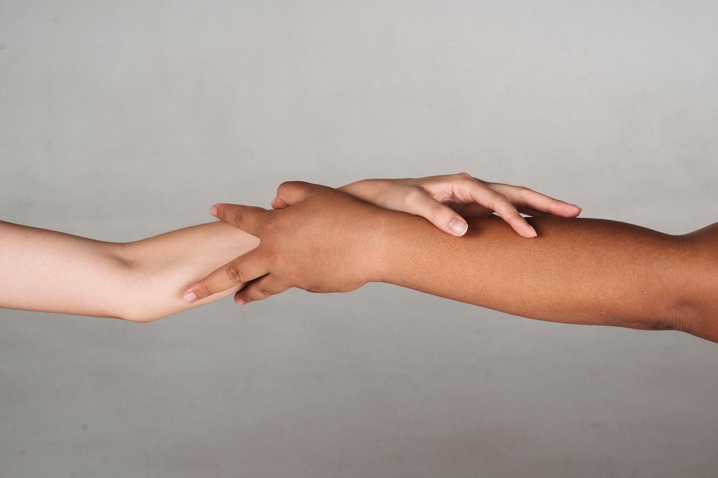 Two people clasping hands in a gesture of support